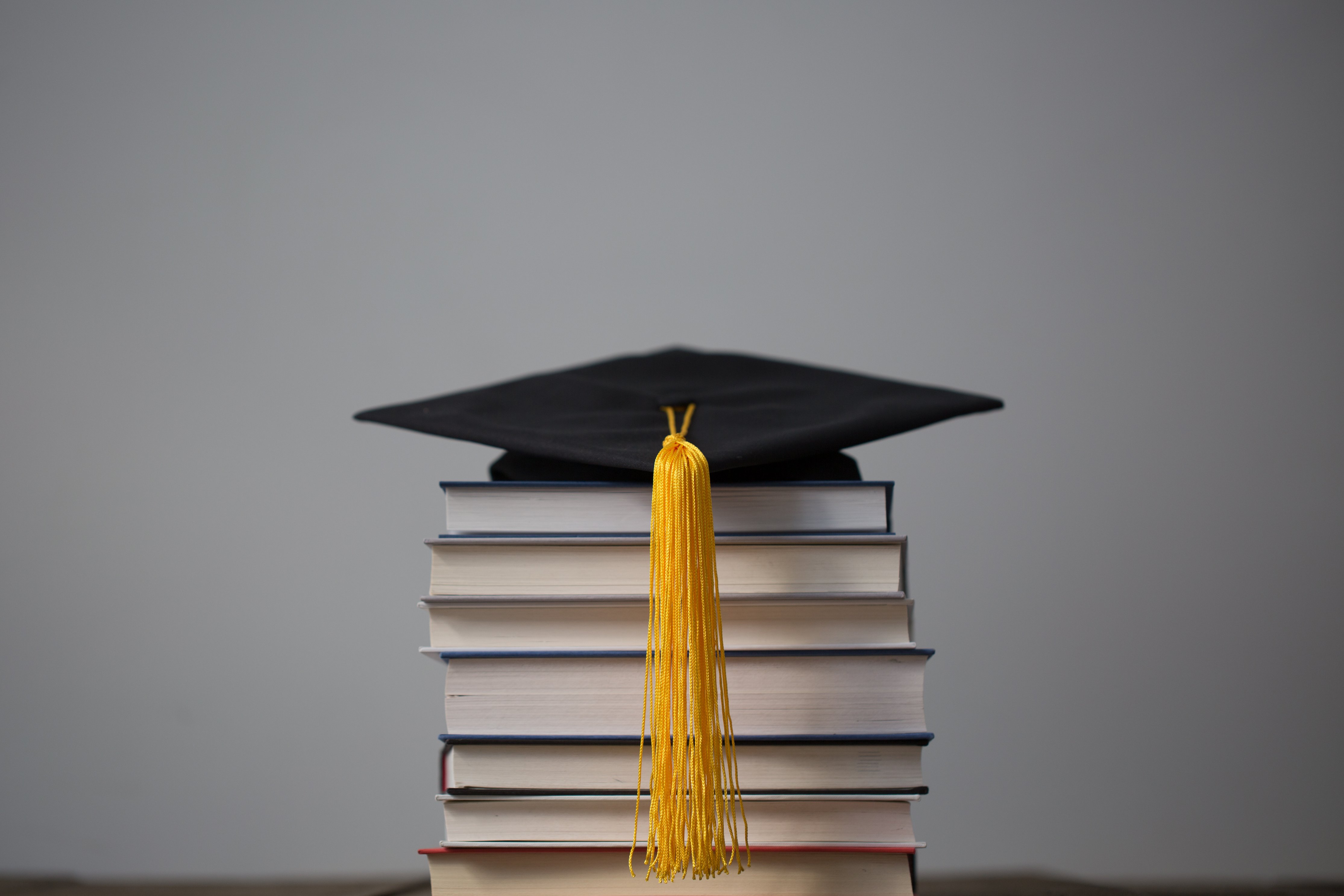 graduation cap on top of books 4460x4460